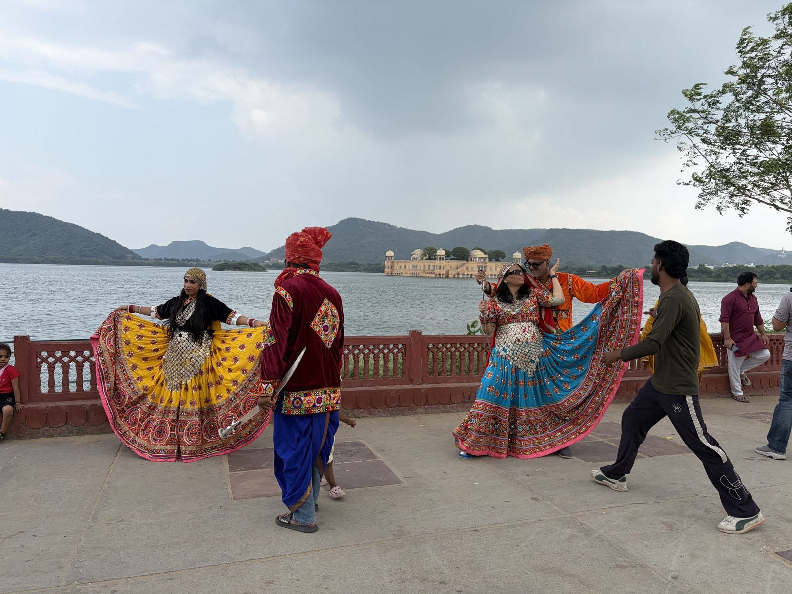 Rajasthani folk dancers in front of Jal Mahal in Jaipur