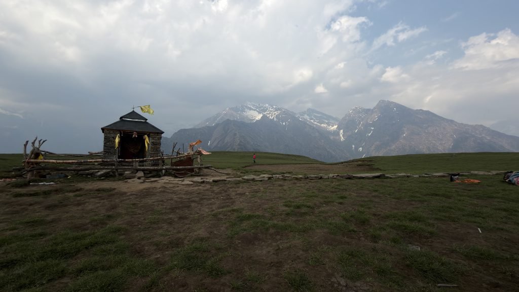 Budha Madhyamaheshwar shrine on the plateau with Chaukhamba peaks beyond