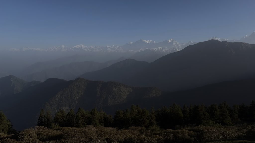 Snow-covered Himalayan peaks above forested ridges near Tungnath